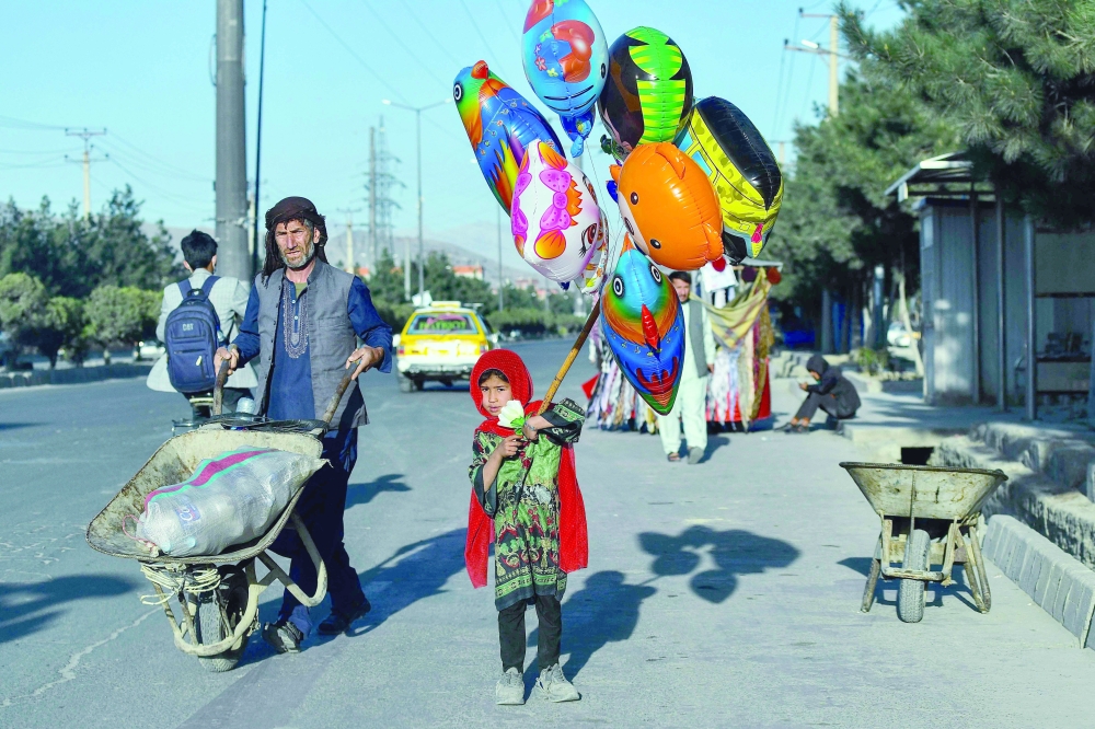 A child sells balloons in Kabul. UN chief Antonio Guterres warned that some 95 per cent of Afghans do not have enough to eat and nine million are at risk from famine. -- AFP