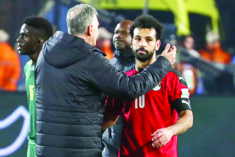 Egypt's coach Carlos Queiroz (L) embraces his forward Mohamed Salah (R). -- AFP
