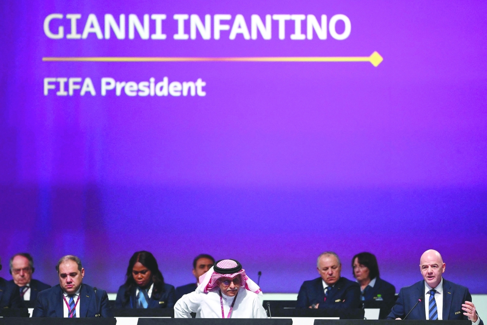 Fifa President Gianni Infantino (R) speaks during the 72th Fifa Congress in the Qatari capital Doha on March 31, 2022.
 The countdown towards the most controversial World Cup in history really begins on Friday as the draw for Qatar 2022 takes place in Doha, less than eight months before the start of the tournament itself. (Photo by FRANCK FIFE / AFP)