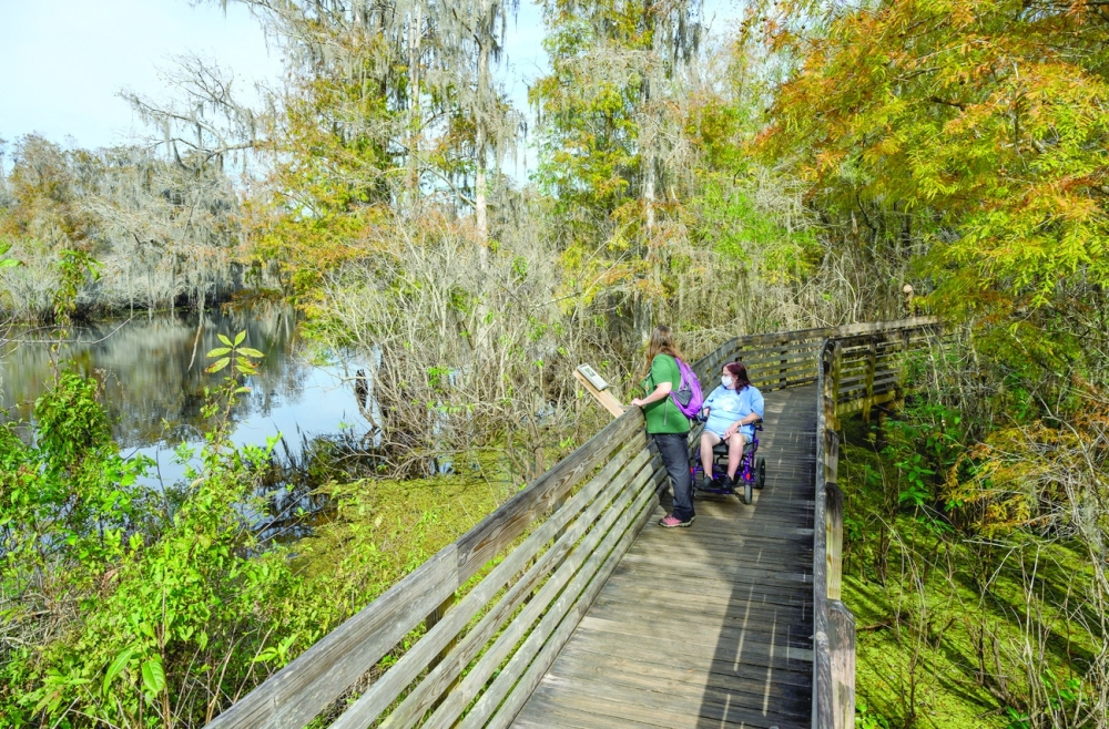 Syren Nagakyrie, left, andVickie Boyer hike in theLettuce Lake Conservation Park in Tampa, Fla., on Dec. 3, 2021.  (Todd Anderson/The New York Times)
