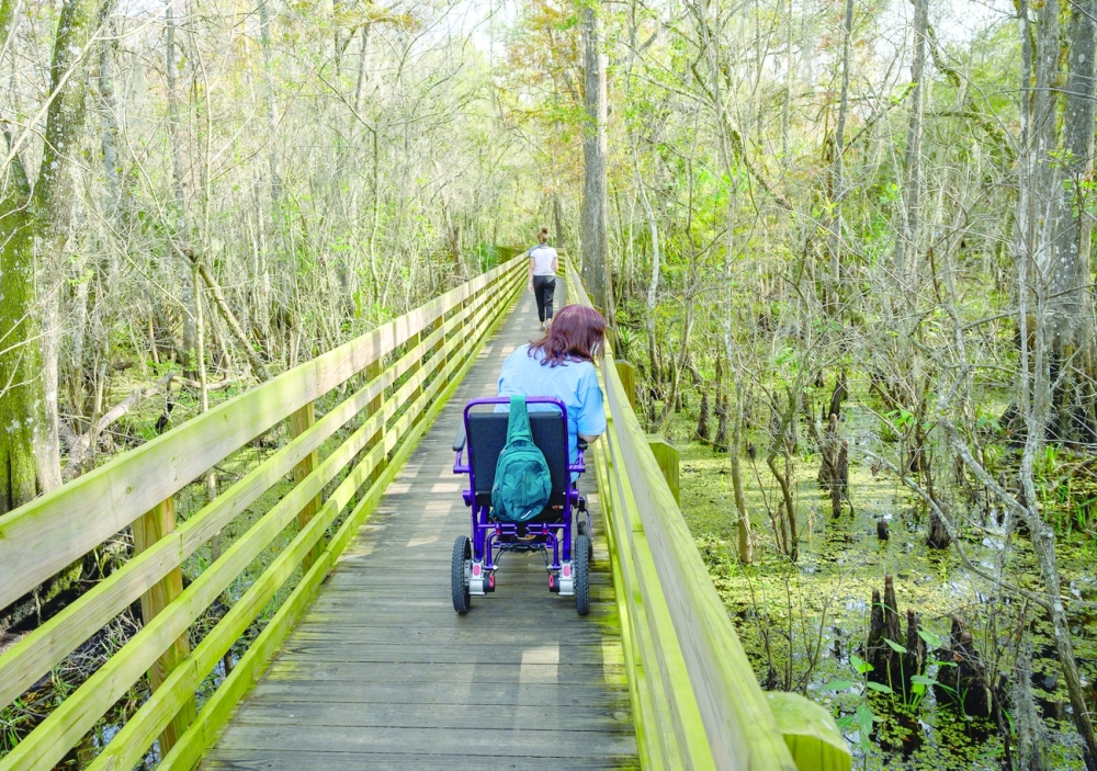 Vickie Boyer on the boardwalk trail at Lettuce Lake Conservation Park in Tampa on Dec. 3, 2021. (Todd Anderson/The New York Times)