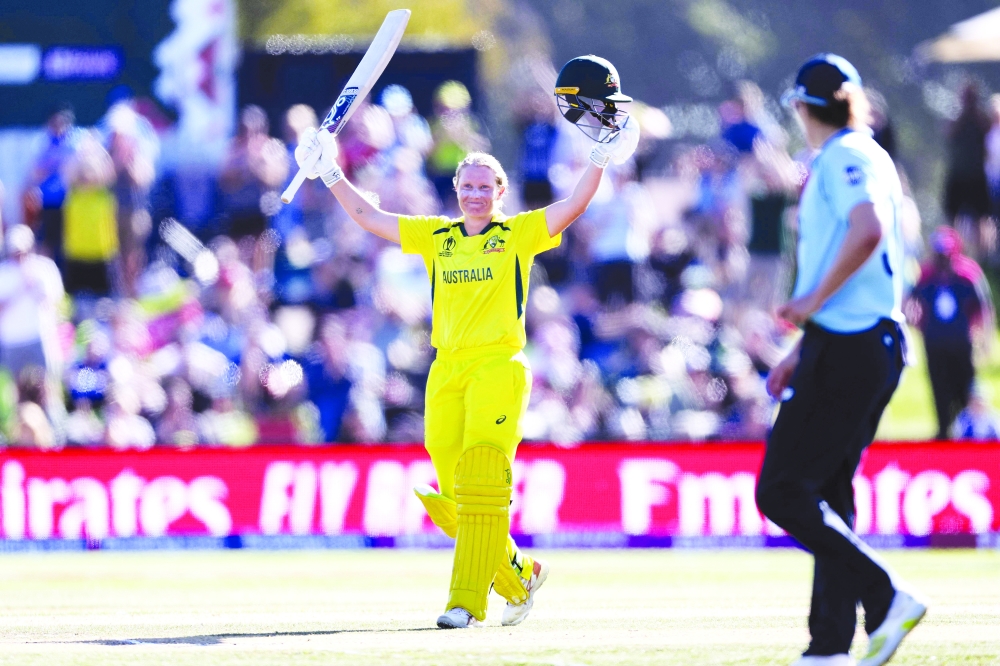 Australia's Alyssa Healy celebrates reaching her century (100 runs) during the 2022 Women's Cricket World Cup final. -- AFP