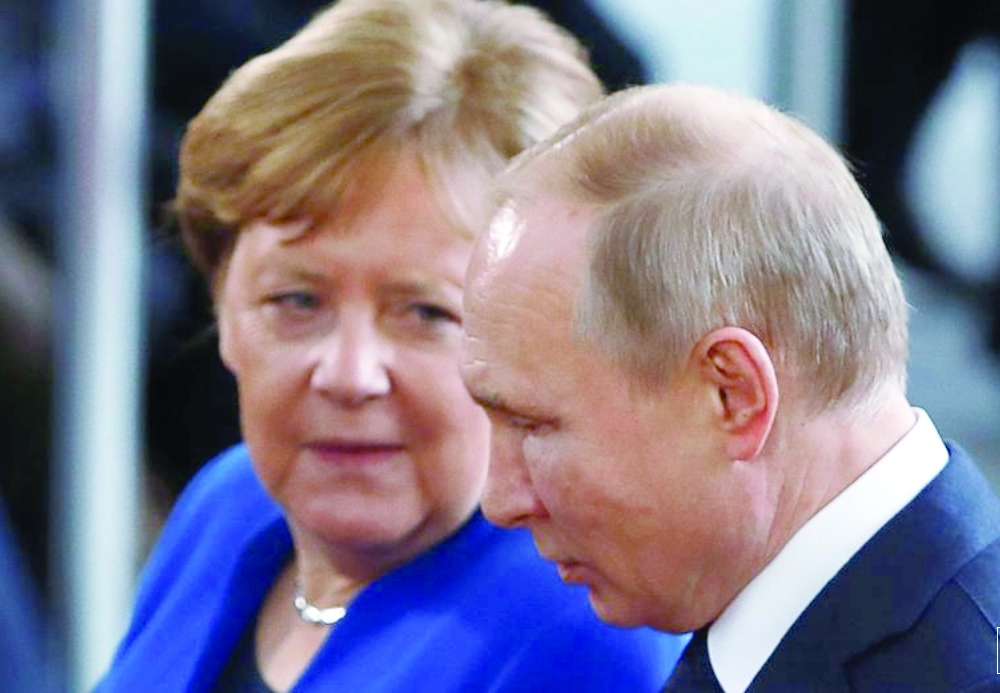 File photo of former German Chancellor Angela Merkel with Russian President Vladimir Putin in Berlin, Germany, on January 19, 2020. - Reuters