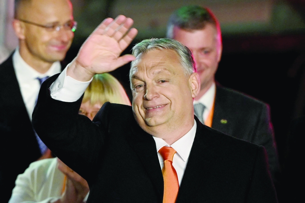 Hungarian Prime Minister Viktor Orban and members of the Fidesz party celebrate on stage at their election base, on the bank of the Danube River of Budapest. - AFP 