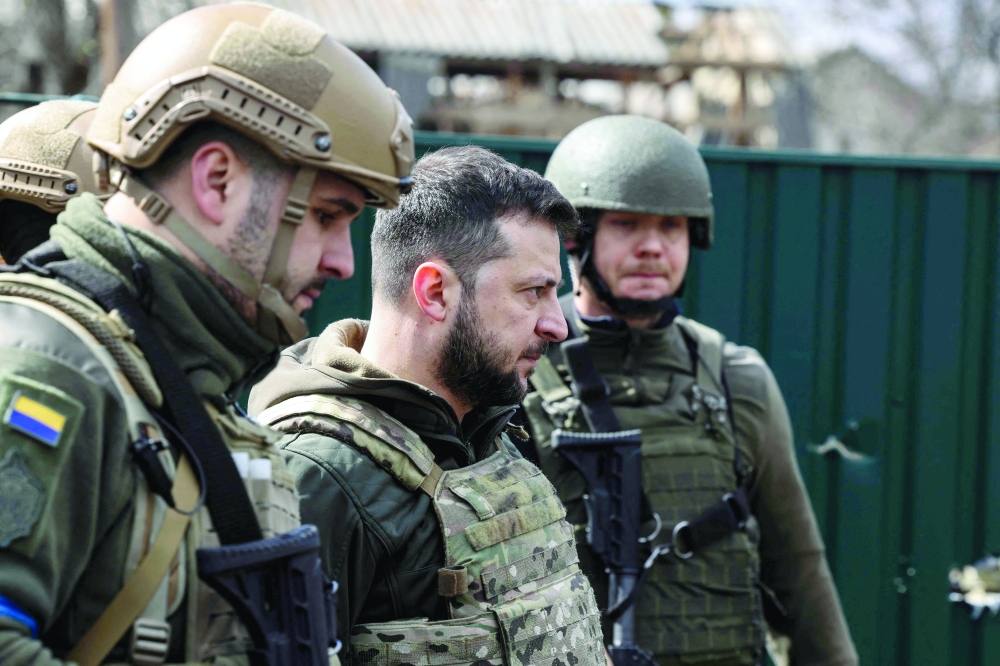 Ukainian President Volodymyr Zelensky walks in the town of Bucha, northwest of the Ukrainian capital Kyiv, - AFP