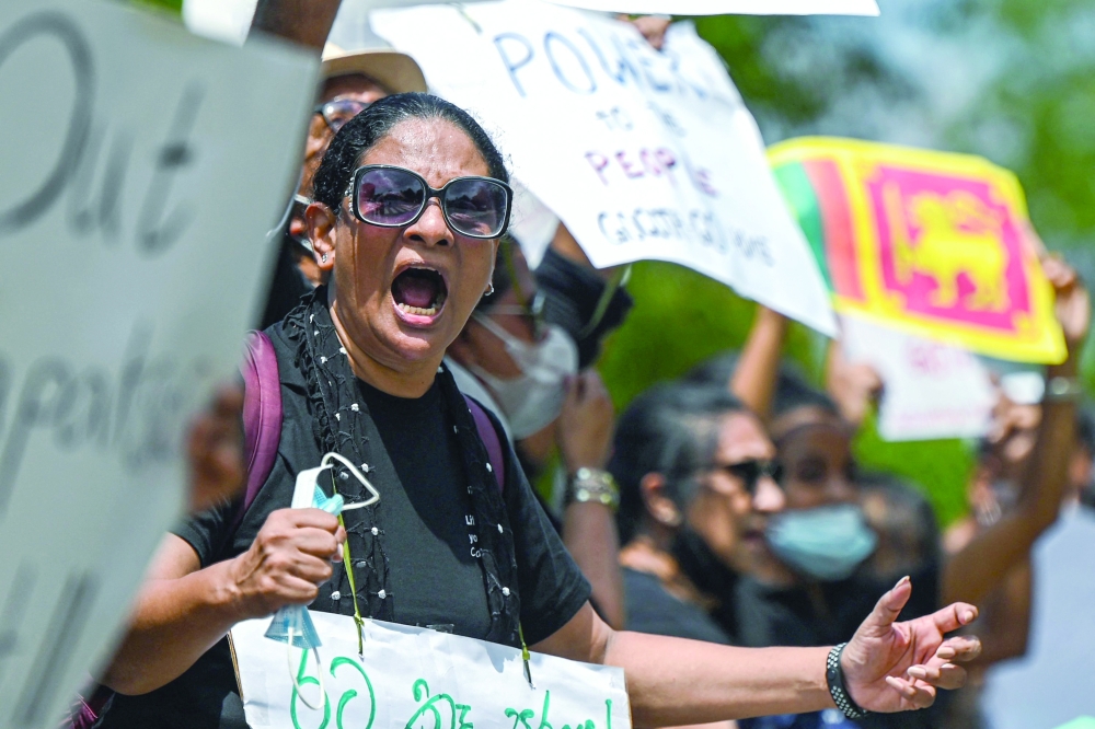 Protestors during a demonstration against the surge in prices and shortage of fuel and other essential commodities in Colombo. - AFP