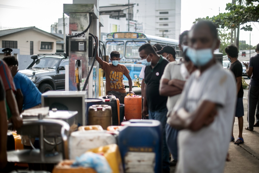 Residents line up for fuel at a gas station in Colombo, Sri Lanka, on Sunday, April 3, 2022. (Rebecca Conway/The New York Times)