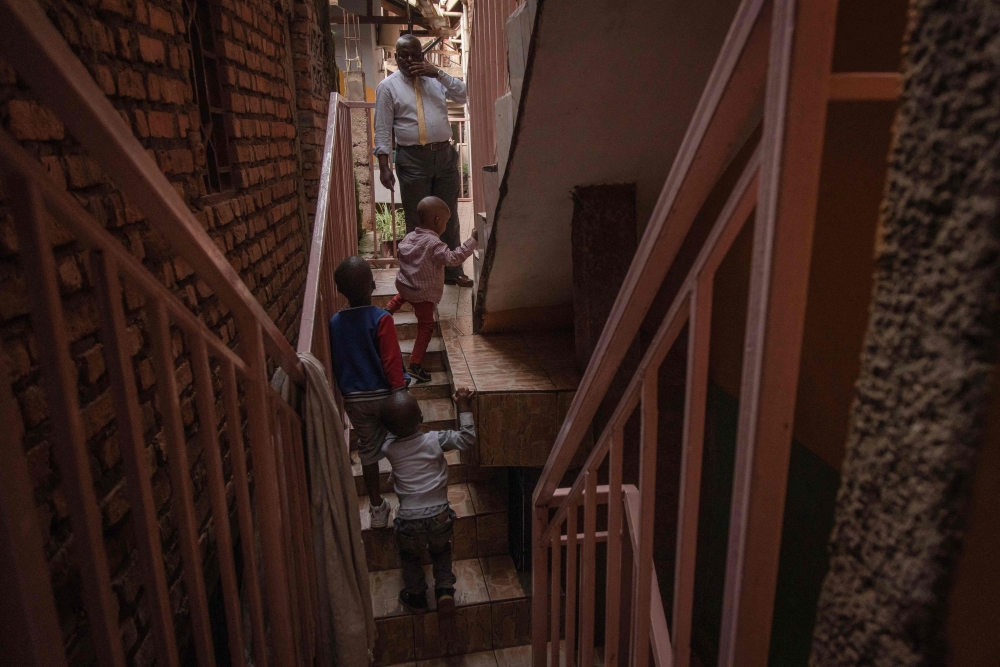 Chirhuza Zagabe (back), 60, pastor of thePrimitive Church of the Lord, calls his children to eat lunch in Bukavu, eastern Democratic Republic of Congo