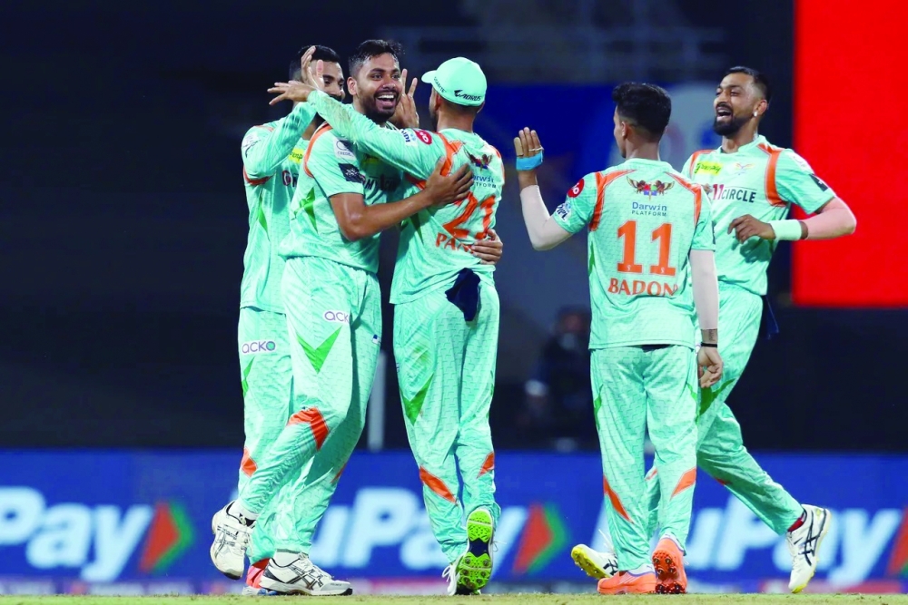 Lucknow's Avesh Khan celebrates a wicket with teammates.