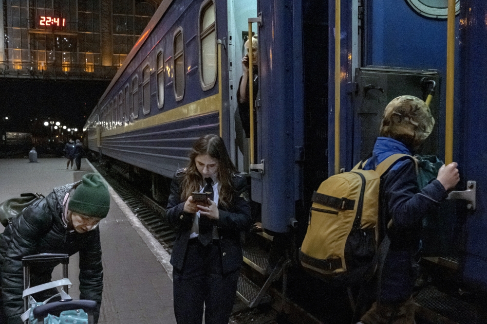 Passengers board a train at the central train station in Lviv, Ukraine, on Monday, April 4, 2022.  (Mauricio Lima/The New York Times)