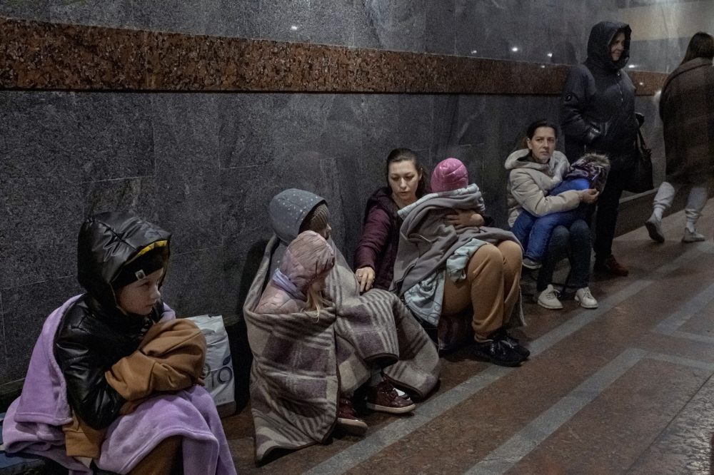 Travelers, many of them mothers holding crying children, take shelter underground when an air-raid siren sounds at the central train station in Lviv, Ukraine, on Monday, April 4, 2022.   (Mauricio Lima/The New York Times)
