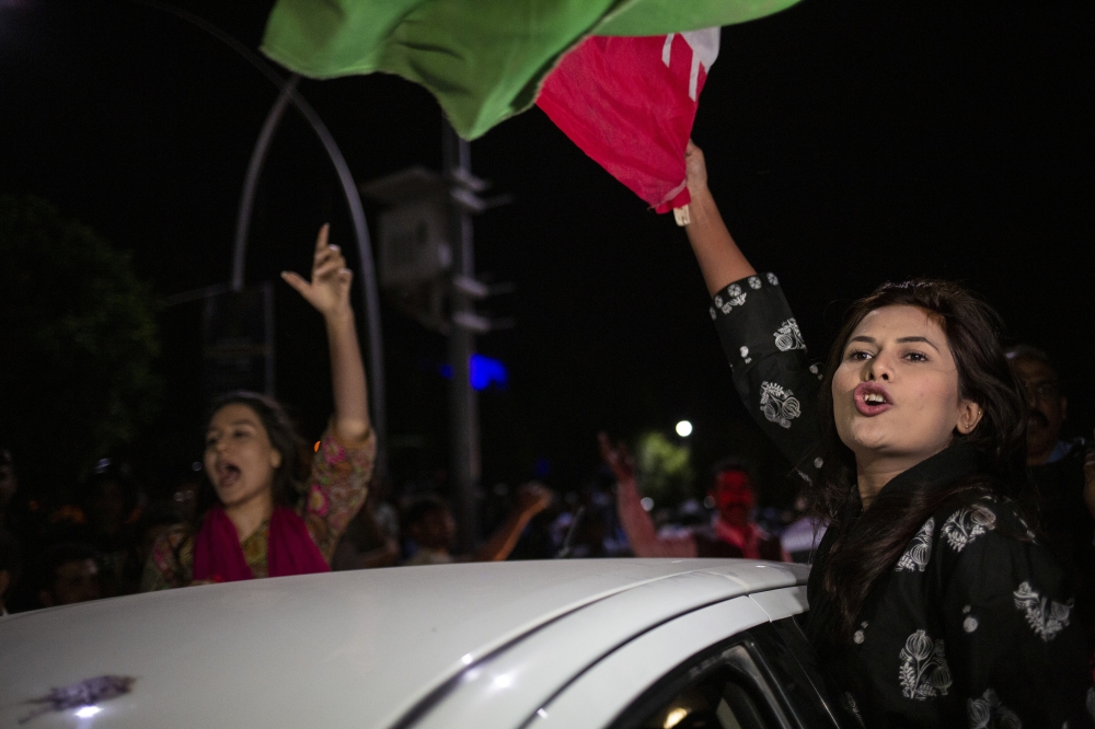 People celebrate outside of Pakistans Supreme Court in Islamabad, Pakistan, April 7, 2022, after its decision to overturned Prime Minister Imran Khans move to dissolve Parliament. (Saiyna Bashir/The New York Times)