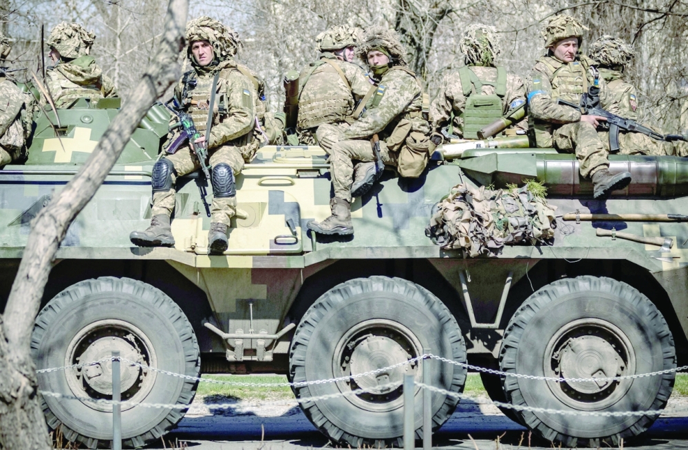 Ukrainian soldiers sit on an armoured military vehicle in the city of Severodonetsk, Donbas region. -- AFP