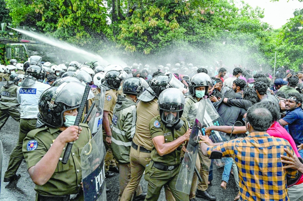 Police use water cannons to disperse university students, protesting against the economic crisis near the Parliament building in Colombo. -- AFP