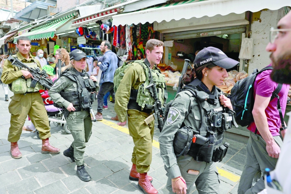 Israeli security forces patrol Jerusalem's Mahane Yehuda market. -- AFP