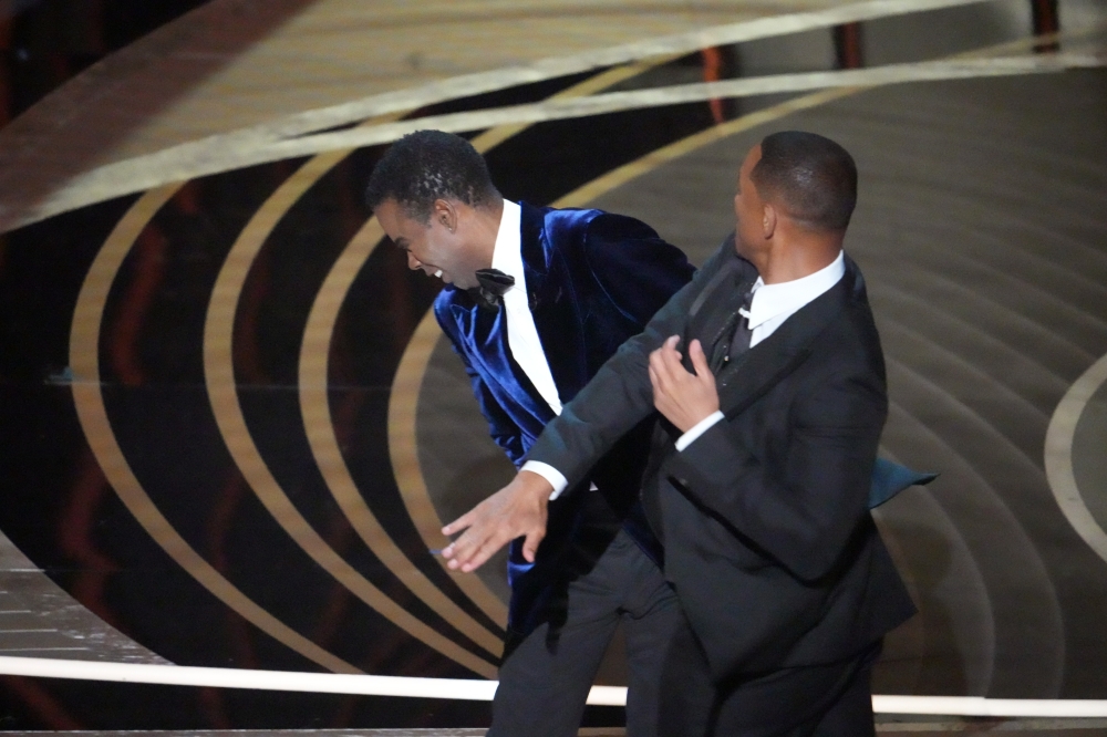 Will Smith walks onstage and slaps Chris Rock after the comedian made a joke about Smiths wife, Jada Pinkett Smith, at the 94th Academy Awards in Los Angeles, on Sunday, March 27, 2022. 