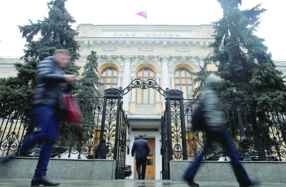 People walk past the headquarters of Russia's Central Bank in Moscow. — Reuters

