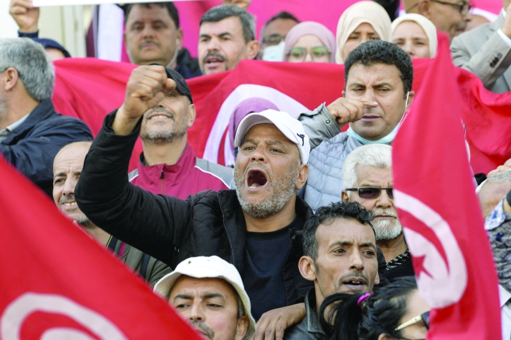 Tunisians take to the streets of the capital Tunis to protest against their president. - AFP