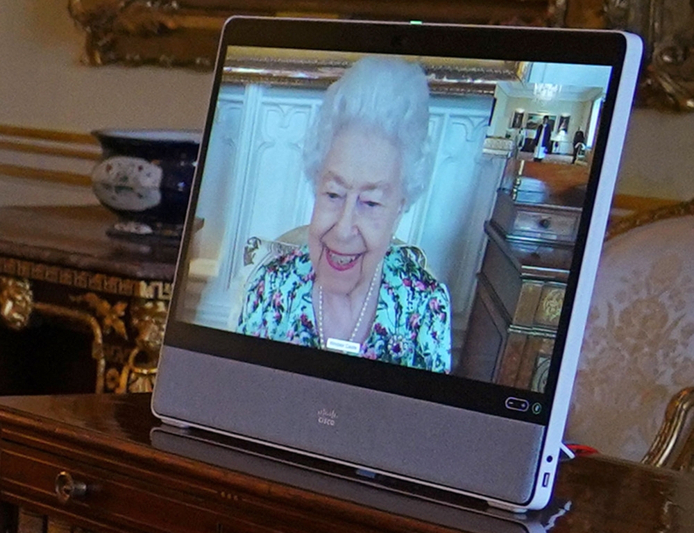 Britain's Queen Elizabeth II, in residence at Windsor Castle, appears on a screen via videolink during a virtual audience to receive Libya's Ambassador to the United Kingdom, at Buckingham Palace in London on April 5, 2022.