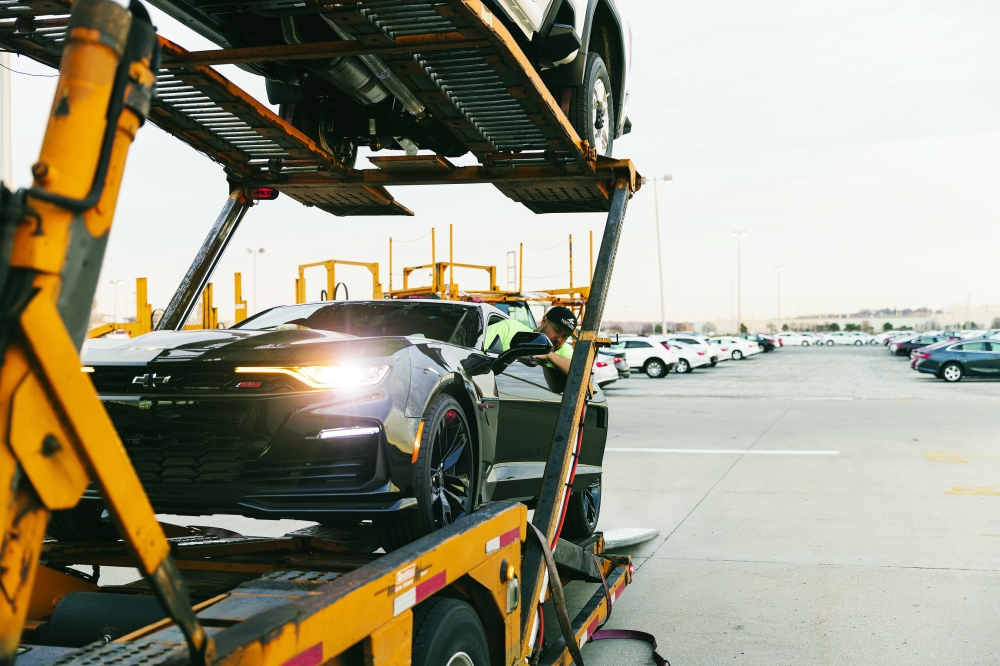 Cars are loaded in Kansas City for transport to a dealership in Wichita, Kansas. — The New York Times