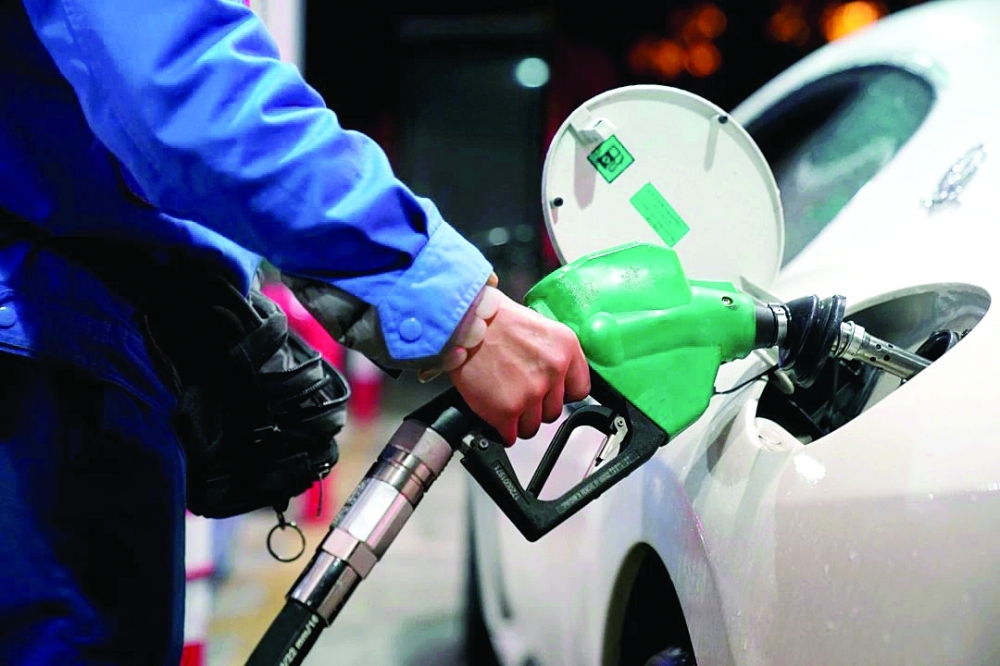 A gas station attendant pumps fuel into a customer's car at a gas station in Shanghai. — AFP
