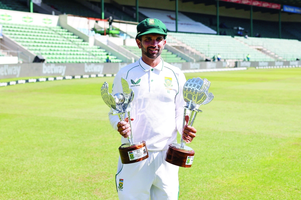 South Africa's Keshav Maharaj poses with his trophies after receiving the player of the match and player of the series awards following the second Test cricket match between South Africa and Bangladesh at St George's Park in Gqeberha on April 11, 2022. (Photo by Marco LONGARI / AFP)

