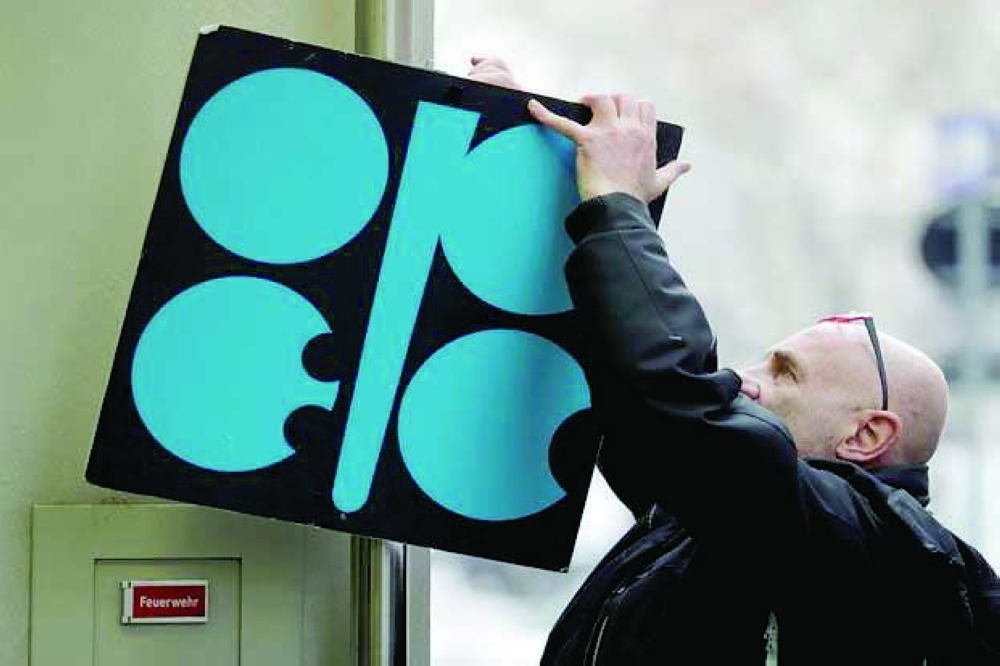 A man fixes the logo of Opec in Vienna. — Reuters