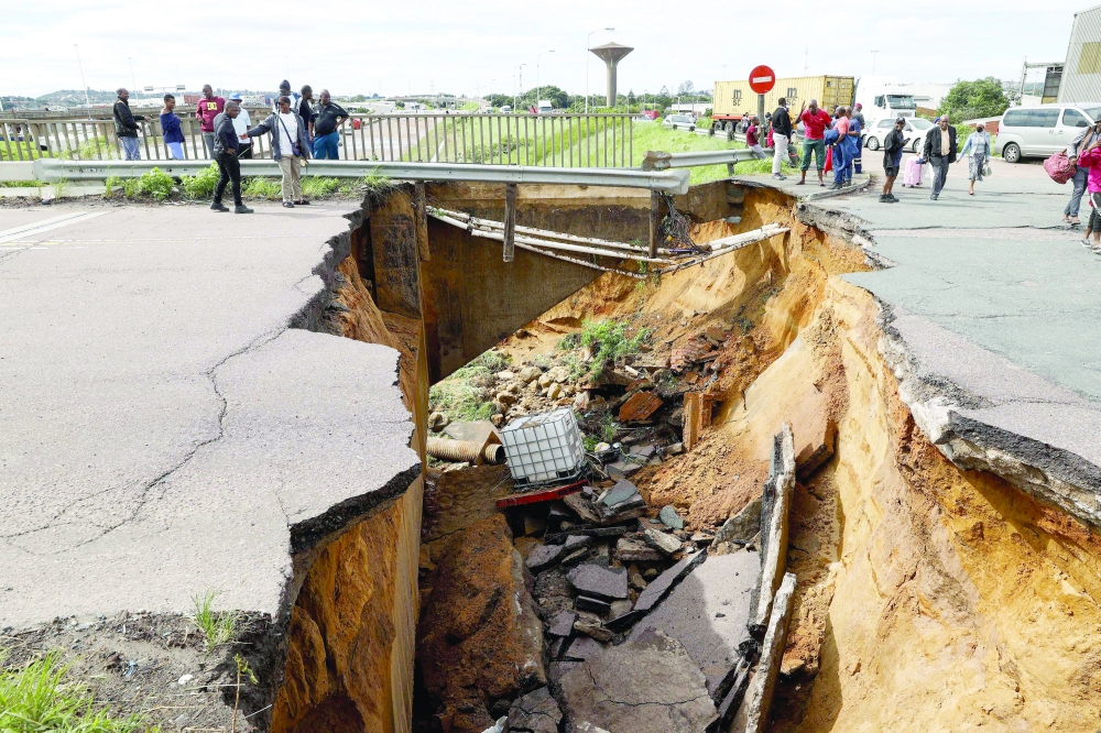 A view of a crack in the road following heavy rains and winds in Durban. - AFP 