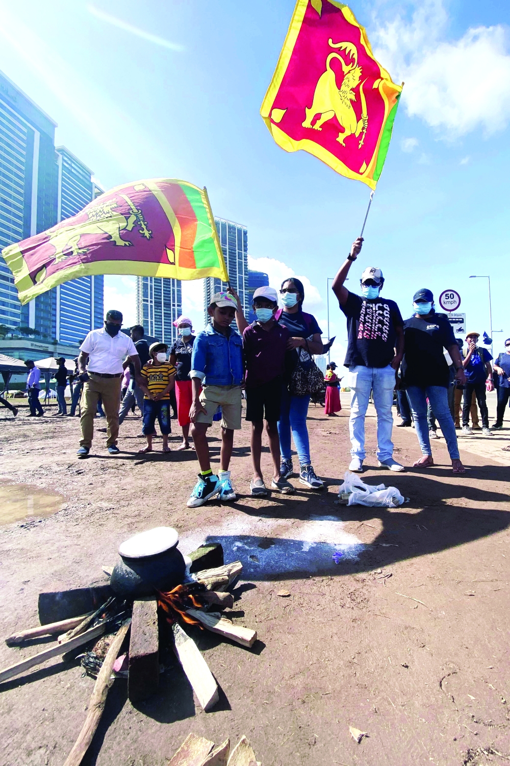 Protesters wave national flags and boil milk to usher in the traditional New Year during an anti-government protest in Colombo. - AFP