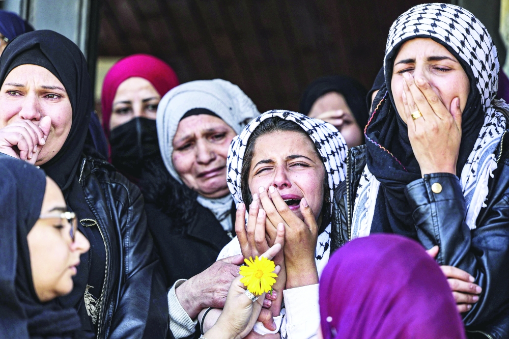 Mourners react during the funeral of Palestinian Amer Elyan Silwad, north of Ramallah in the occupied West Bank, on Thursday. - AFP