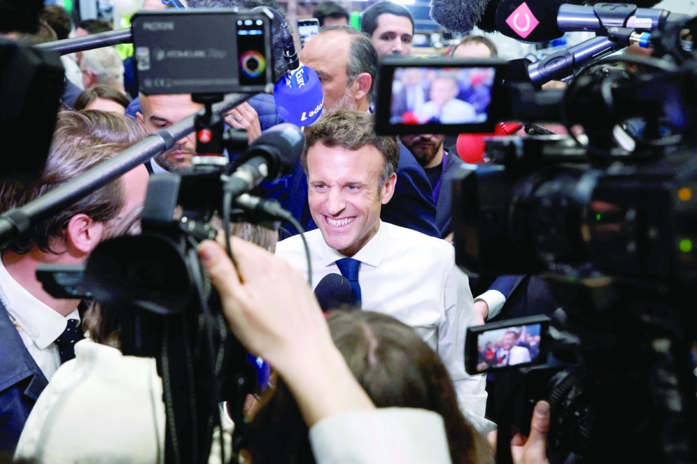French President and liberal party La Republique en Marche (LREM) candidate for re-election Emmanuel Macron speaks to the press during a visit at the Siemens Gamesa's factory, which produces wind turbines, in Le Havre, northwestern France, on Thursday. - AFP