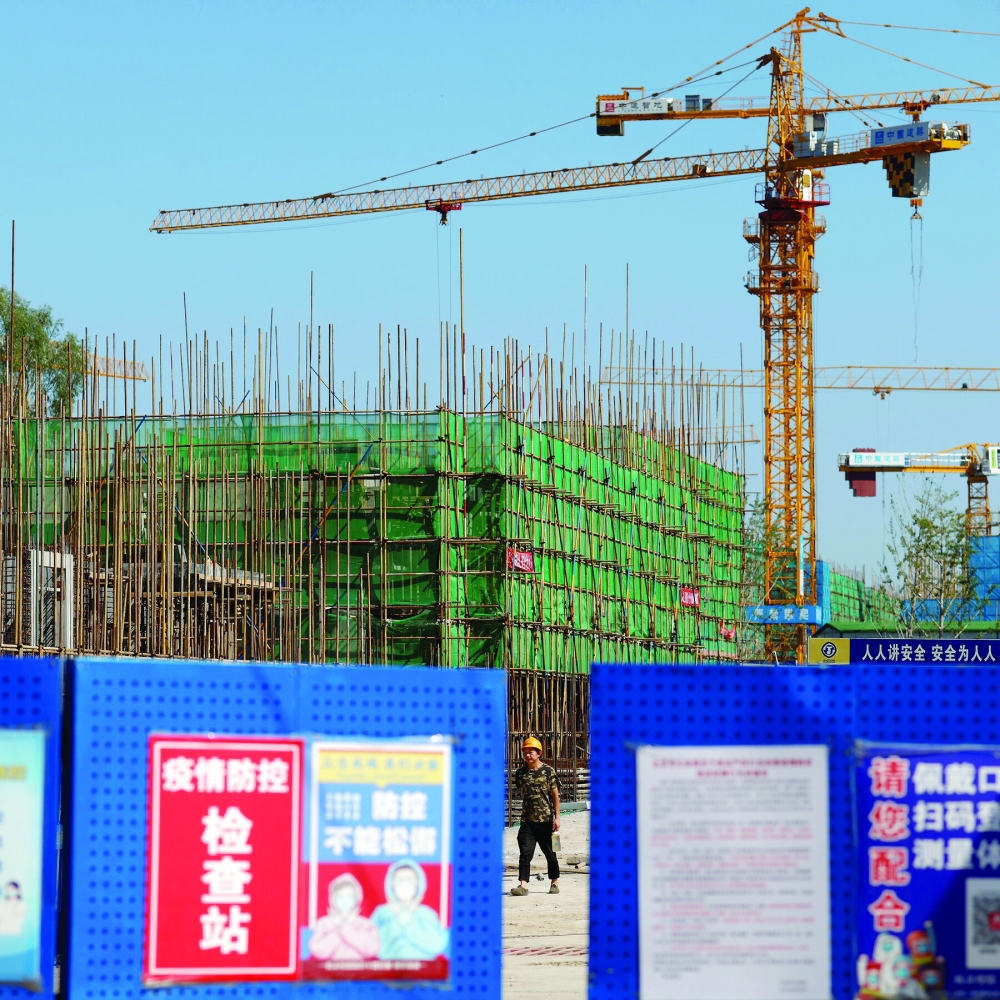 A man in seen in a construction site in Beijing. — AFP