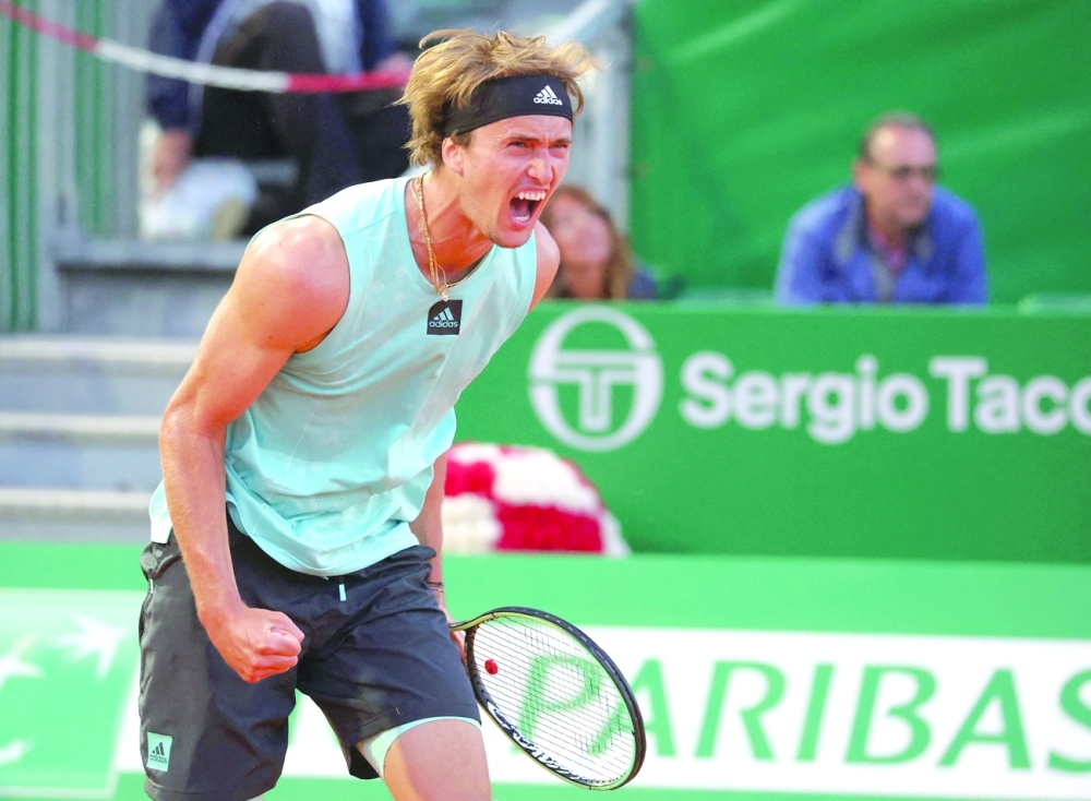 Germany's Alexander Zverev celebrates after winning his quarterfinal Monte-Carlo ATP Masters Series tournament tennis match against Italy's Jannik Sinner in Monaco on April 15, 2022. (Photo by Valery HACHE / AFP)