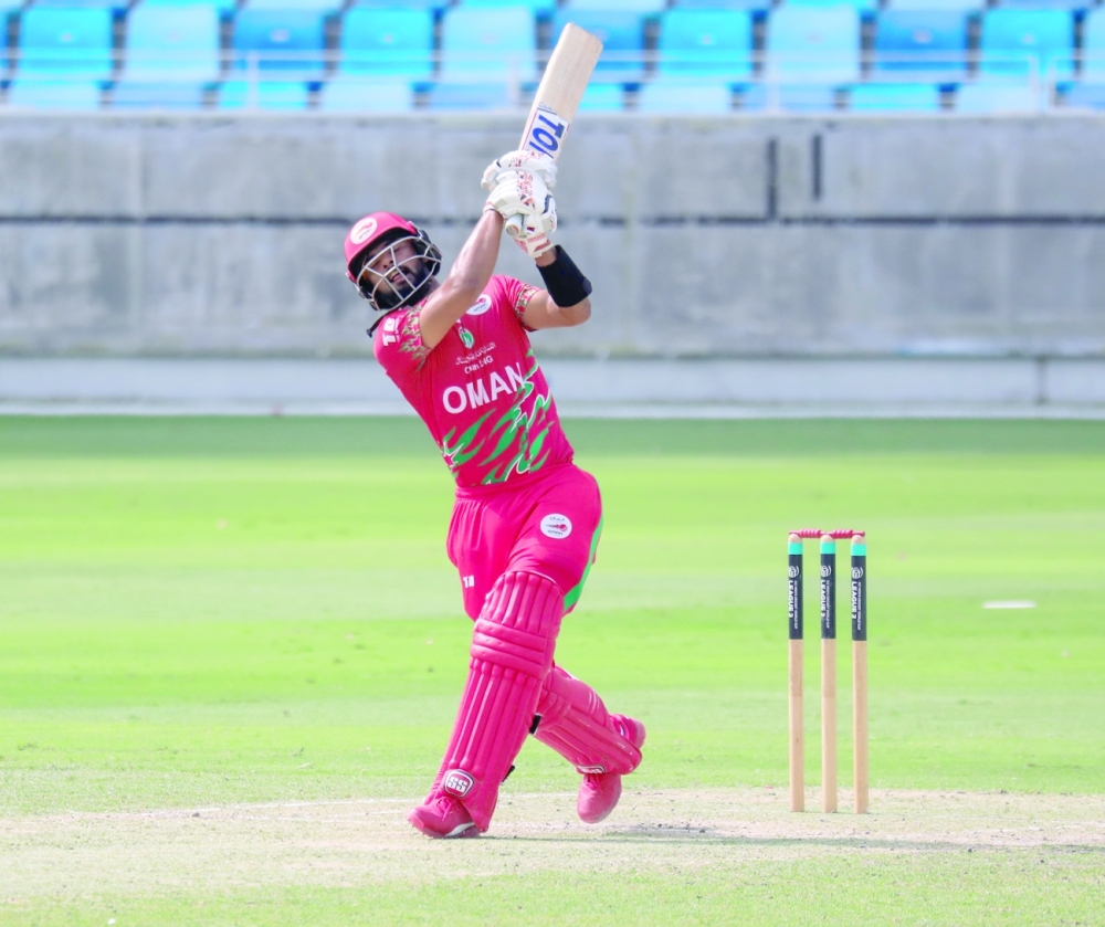 Oman's Kashyap Prajapati plays a shot against Scotland.
