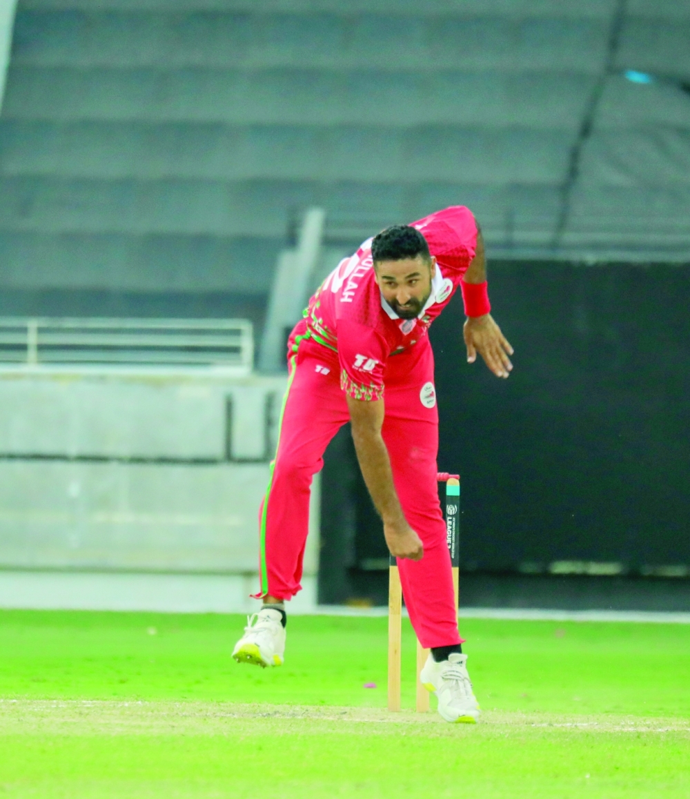 Oman's Kaleemullah bowls against Scotland.