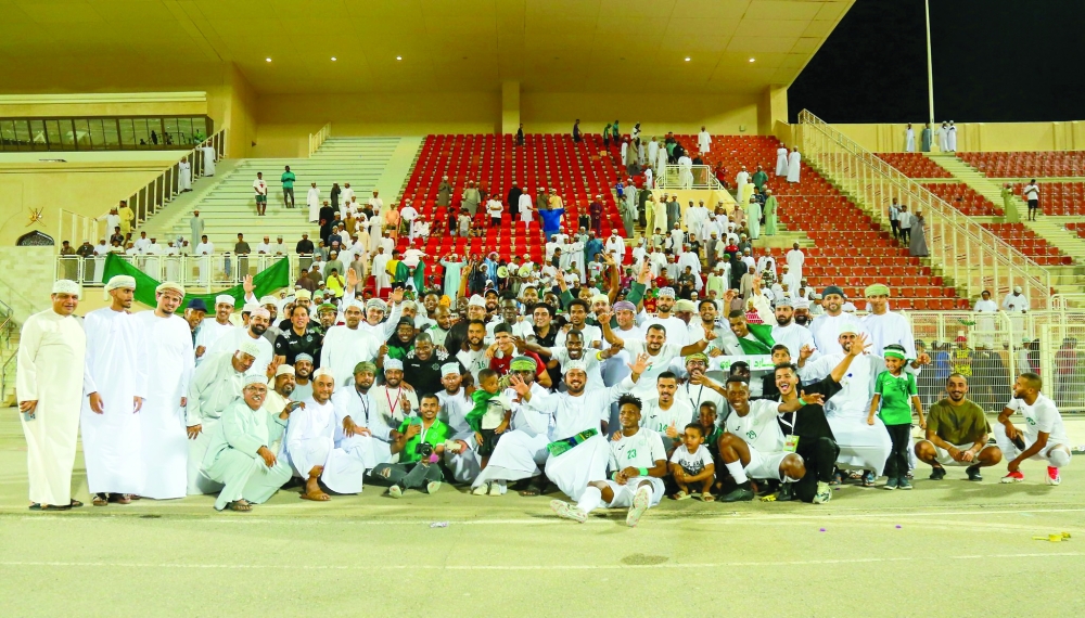 Al Oruba team members celebrate after their promotion to Omantel League.