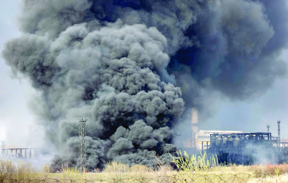 Smoke raises from an oil refinery in Lysychansk about 120km north of Donetsk, on Saturday. - AFP 
