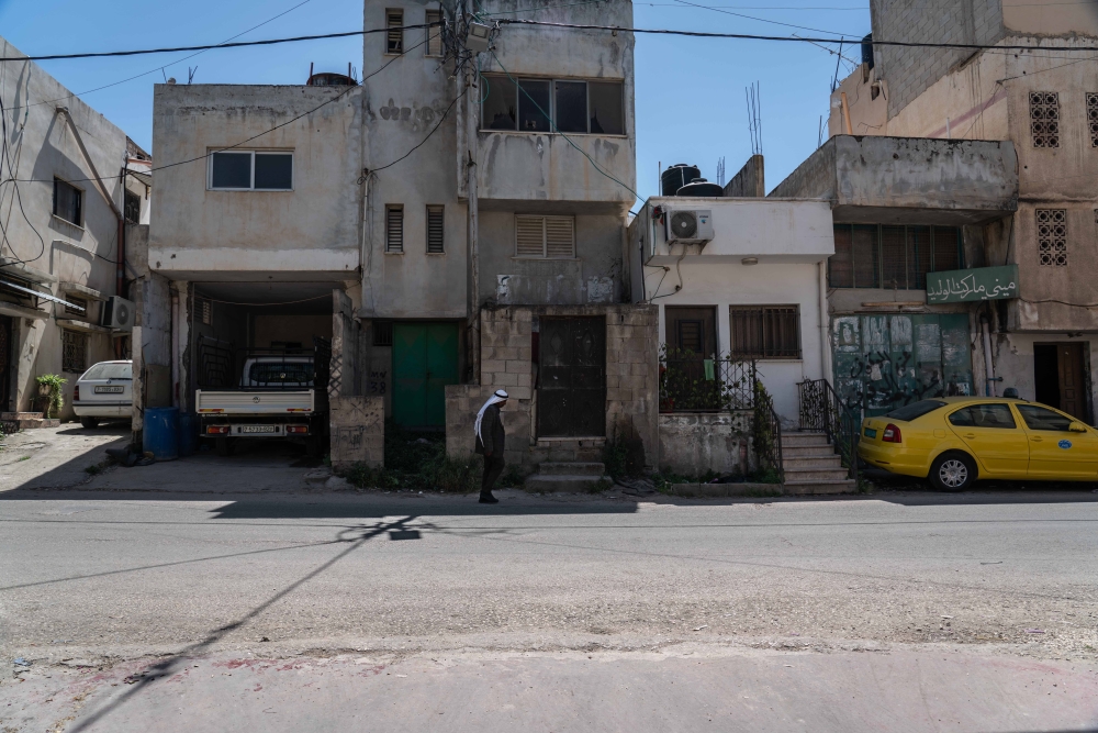 A Palestinian man walks in the refugee camp in the West Bank city of Jenin, on April 15, 2022. (Samar Hazboun/The New York Times)