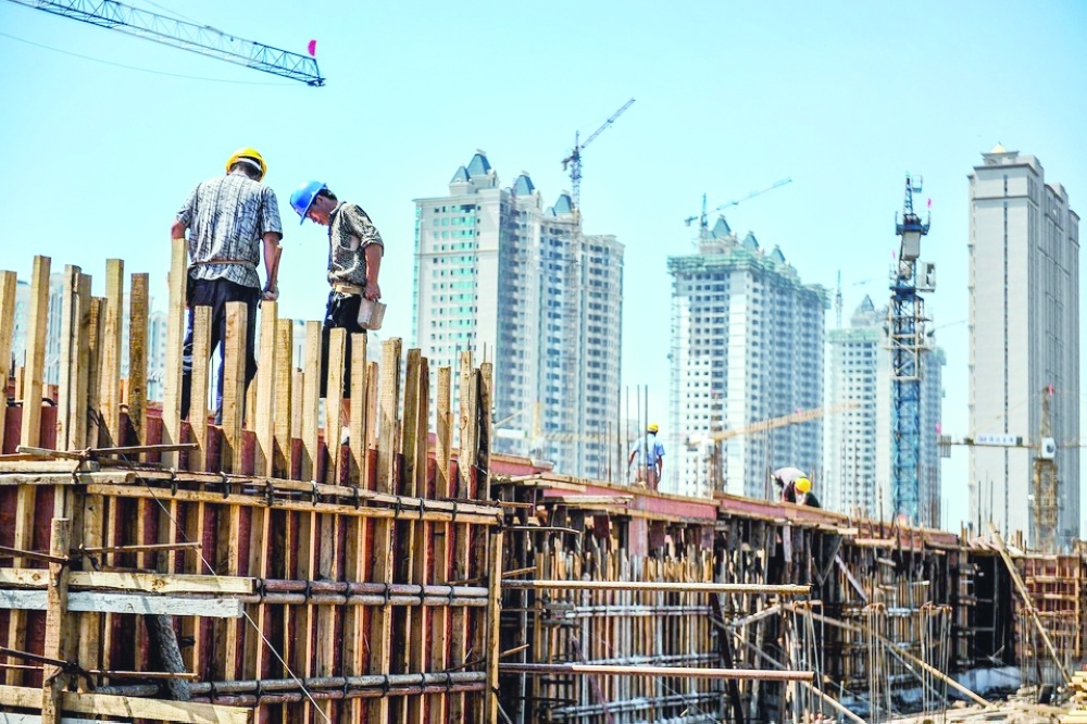 Labourers work at a construction site in Beijing, in this file photo. — AFP