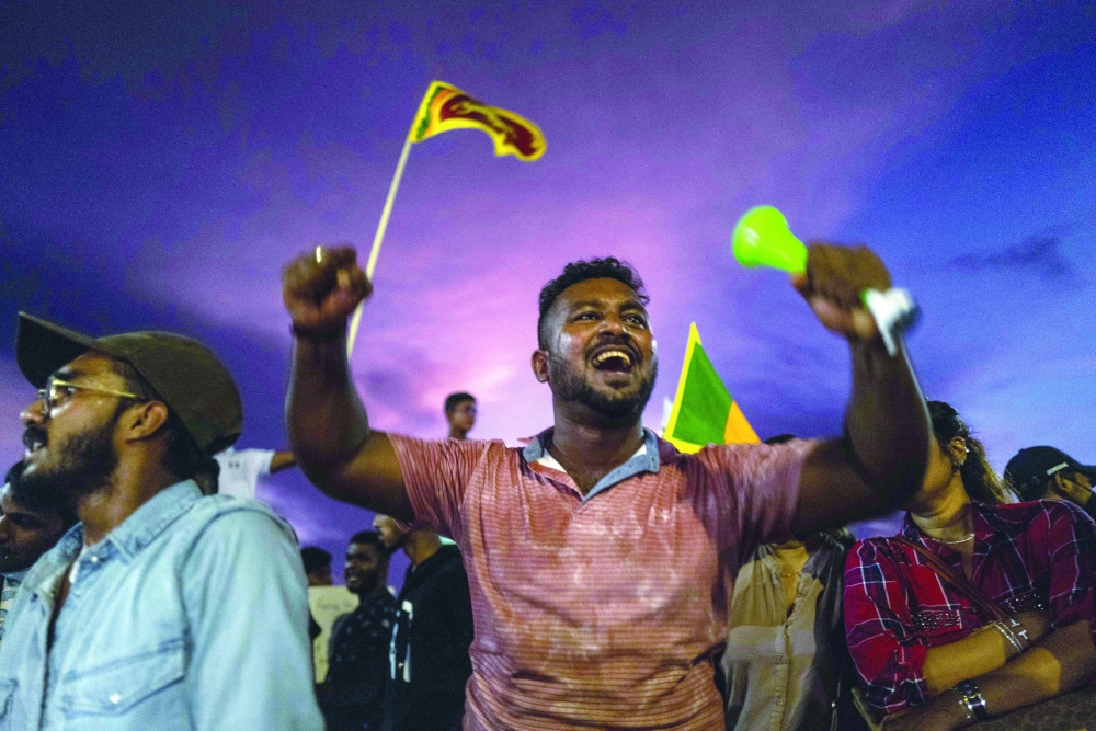 Sri Lankans shout slogans during an ongoing anti-government demonstration near the president's office in Colombo on Sunday. - AFP

