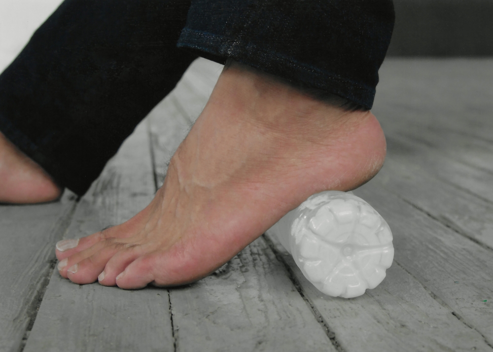 A foot massage with a frozen water bottle, which helps minimize pain and inflammation, in New York, April 11, 2022.