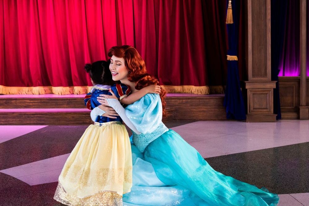 Ollie Romano hugs Ariel from The Little Mermaid at Disneyland in Anaheim, Calif., where a two-year ban on character embraces ended on Monday, April 18, 2022. (Alex Welsh/The New York Times)