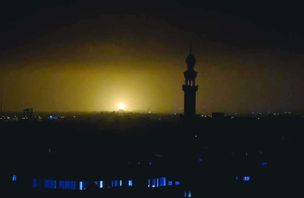 Flames and smoke rise during Israeli air strikes in Rafah in the southern Gaza Strip. - AFP