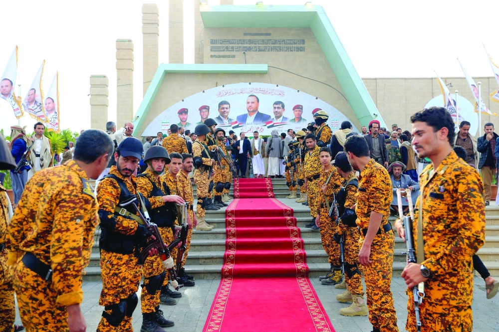 Fighters loyal to Ansar Allah visit the grave of slain political leader Saleh al Sammad at Al Sabeen square in Sanaa on the fourth anniversary of his death in 2018. - AFP