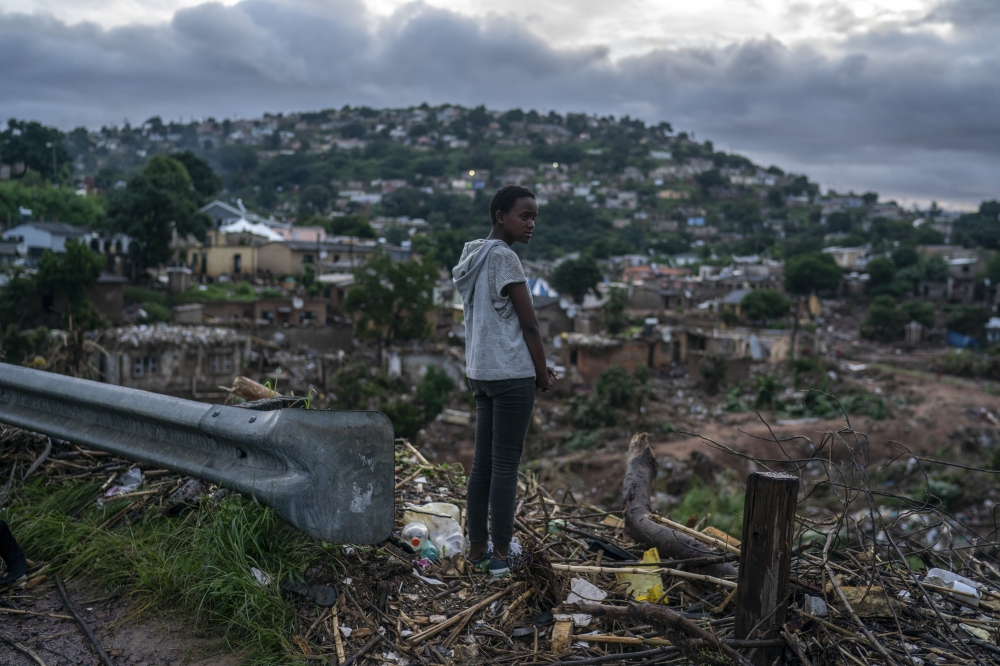 Looking over homes destroyed in last week’s flooding in Inanda, north of Durban, in Kwazulu-Natal Province in South Africa, April 18, 2021. (Joao Silva/The New York Times)