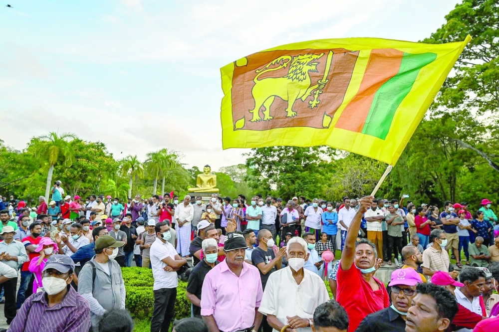 Janatha Vimukthi Peramuna (JVP) party activists shout anti-government slogans during a demonstration in Colombo. - AFP