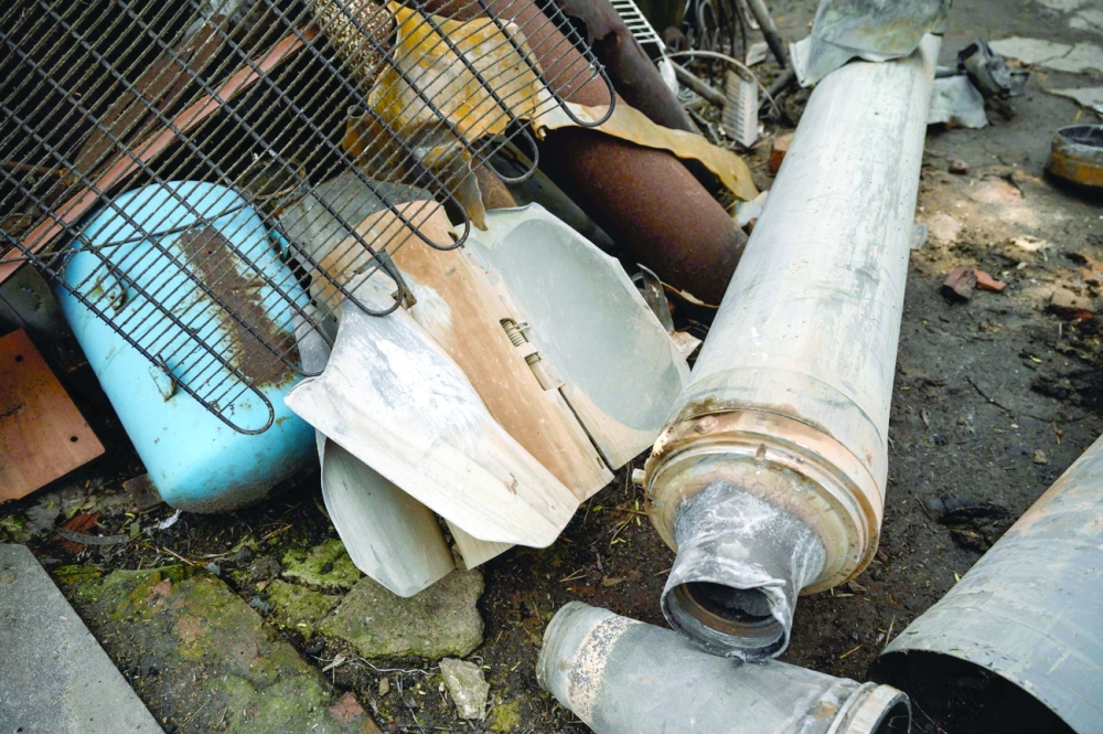 A rocket understood to have been launched from a Soviet-era BM-27 Uragan launcher is seen beside the house of the Los family in the village of Mala Tomachka, south of Zaporizhzhia. - AFP