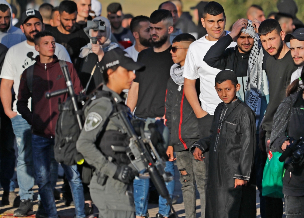 Israeli security forces keep Palestinians at bay in front of the Damascus Gate in Jerusalem's Old City