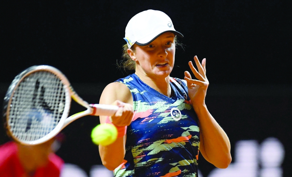 Poland's Iga Swiatek serves to Germany's Eva Lys (not in the picture) during their single match of the Women's Tennis Grand Prix WTA 500 tournament in Stuttgart, southwestern Germany, on April 20, 2022. (Photo by THOMAS KIENZLE / AFP  / AFP)