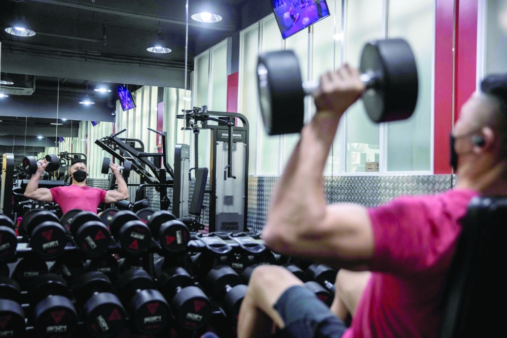 A man works out at a gym in Hong Kong on Thursday, after the government eased some of the Covid-19 restrictions. - AFP